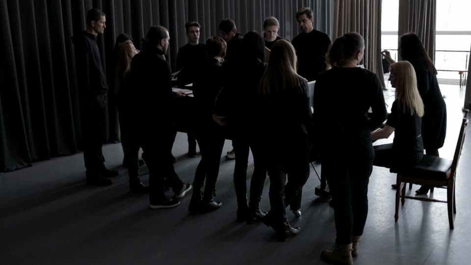 Musicians preparing together around a piano